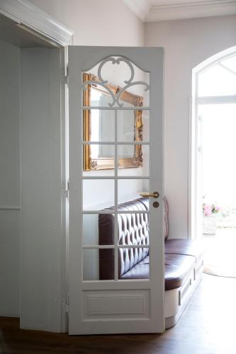a white door with a bench in a room at Stella Maris in Svendborg