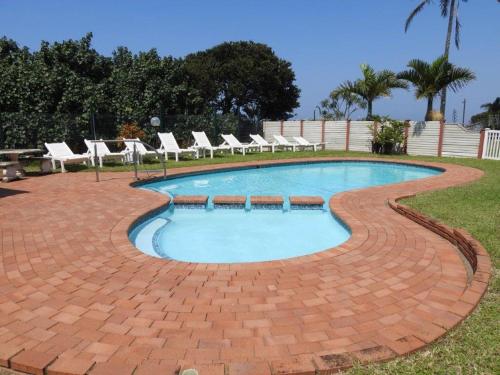 a swimming pool with lounge chairs around it at Marlicht Vacation Resort in Margate