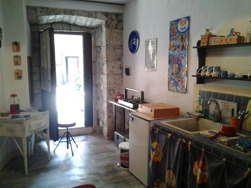 a kitchen with a sink and a table and a window at Apartment Seminello in Pitigliano