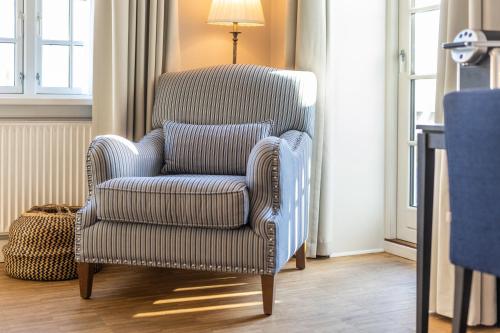 a blue chair with a pillow in a room at Stella Maris in Svendborg