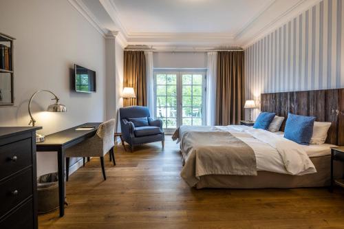a bedroom with a bed and a desk and a chair at Stella Maris in Svendborg