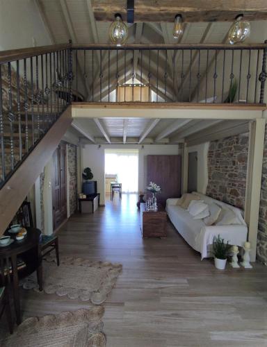 a living room with a bed and a staircase at Angel's Suites 2 in Samos