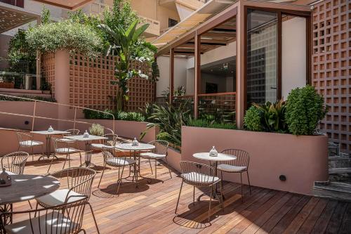 a restaurant with tables and chairs on a patio at Civitel Akali Hotel in Chania Town