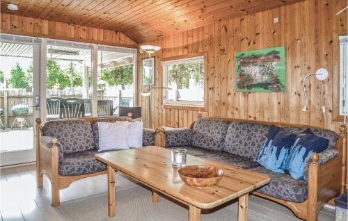 a living room with a couch and a table at Three-Bedroom Holiday Home In Oksbol in Oksbøl