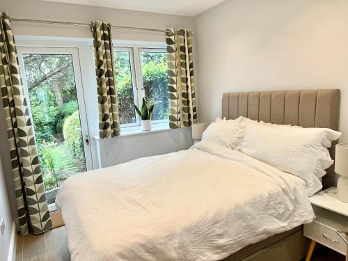 a bedroom with a bed and a window at Little Vine - Beautiful Ground floor flat in South London in Sutton