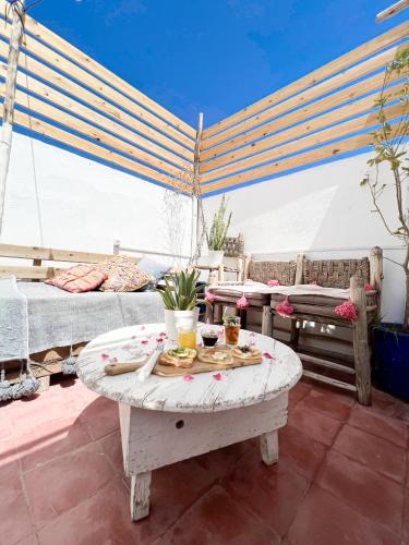 a living room with a table with food on it at Boho 27 Hostel Marrakech in Marrakech