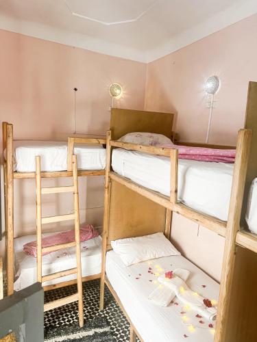 a dorm room with three bunk beds in it at Boho 27 Hostel Marrakech in Marrakech