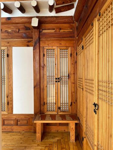 a room with wooden walls and a wooden bench at SeoulStory Hanok in Seoul