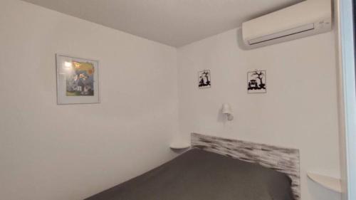 Cette chambre blanche est dotée d'une cheminée en pierre. dans l'établissement Entre terre mer et golf, à Mandelieu-la-Napoule