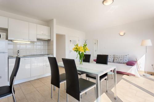 a kitchen and dining room with a table and chairs at Adriatic Queen Residence in Split