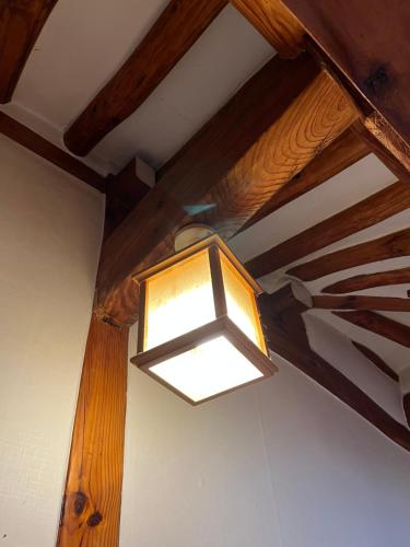 a light hanging from the ceiling of a room at SeoulStory Hanok in Seoul