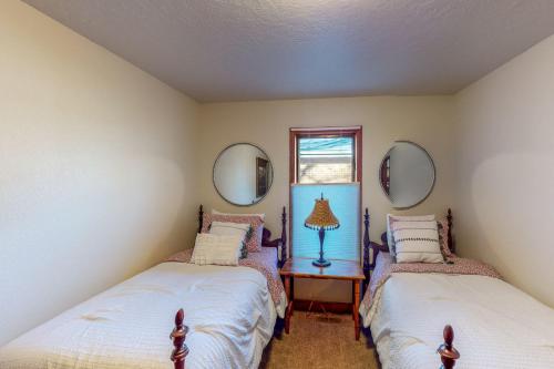 two beds in a room with two mirrors at Nanacitas Casita in Greeley