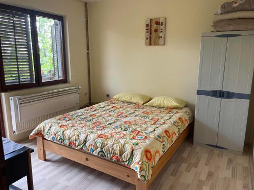 a bedroom with a bed and a window at Hostel Drenak in Gornje Rataje