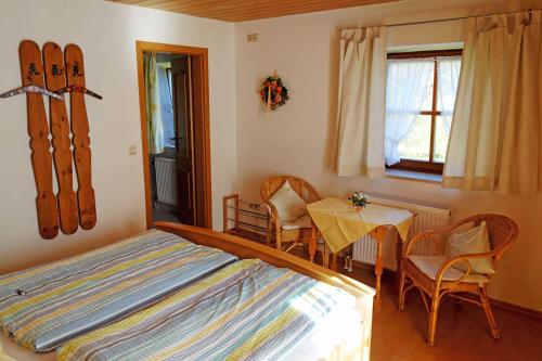 a bedroom with a bed and a table and chairs at Ferienwohnungen mit Bergblick in Inzell
