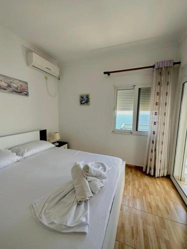 a bedroom with a bed with towels on it at Albania Dream Apartment 31 in Metogjashta