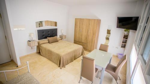 Télévision ou salle de divertissement dans l'établissement Apartahotel Énfasis-Group