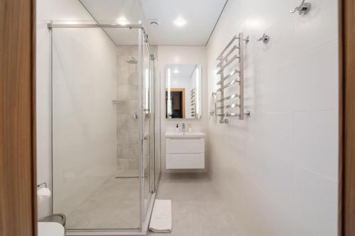 a bathroom with a shower and a sink at Ambassador Orient in Bishkek