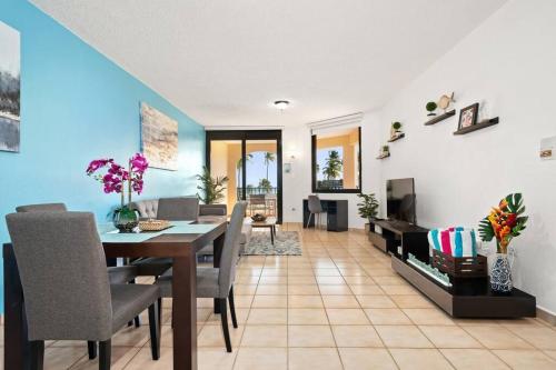 a dining room and living room with a table and chairs at BEACH ACCESS + 3 Pools + OCEAN VIEWS - 2BR In Palmas - Sleeps 7 in Humacao