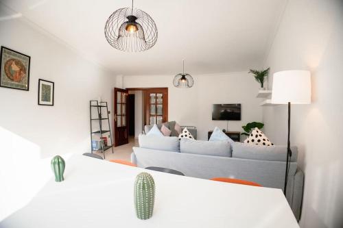 a white living room with a couch and a table at Casa Bella Lalin- 4 Double bedroom Galician Country Home! in Pontevedra