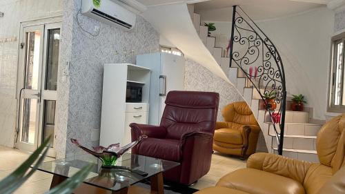 a living room with two chairs and a table at PEACE GUEST HOUSE in Yaoundé