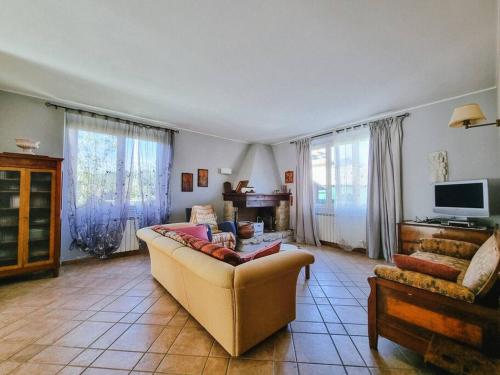 a living room with a couch and a tv at BarberinoRelax in Barberino di Mugello