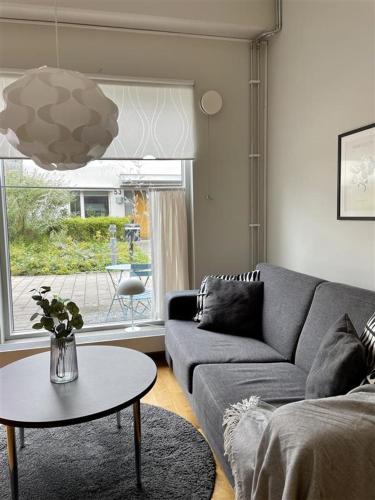 a living room with a couch and a table at Forenom Apartments A-R Lorents Gata - Majorna in Gothenburg