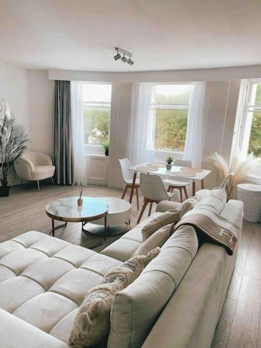 a living room with a white couch and a table at Brighton Apartment by Pier in Brighton & Hove