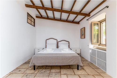 Ein Bett oder Betten in einem Zimmer der Unterkunft Masseria Abbracciavento - Le Camere