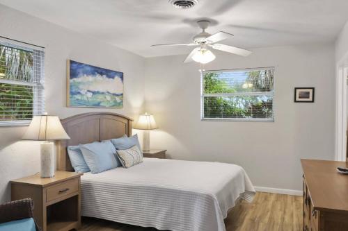 a bedroom with a bed and a ceiling fan at Palm Paradise Waterfront Home - Flagler Beach - Dock - Pet Friendly - Close To The Beach in Flagler Beach