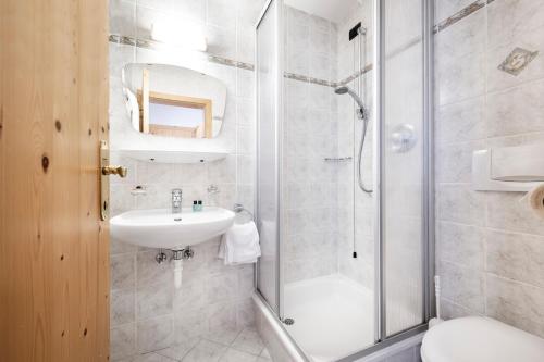 a bathroom with a shower and a sink at Berghotel Schlemmer in Bressanone