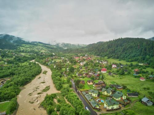 an aerial view of a town next to a river at Emerald House in Mykulychyn