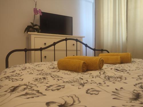 a bed with yellow pillows on top of it at The Moon Residence in Bucharest