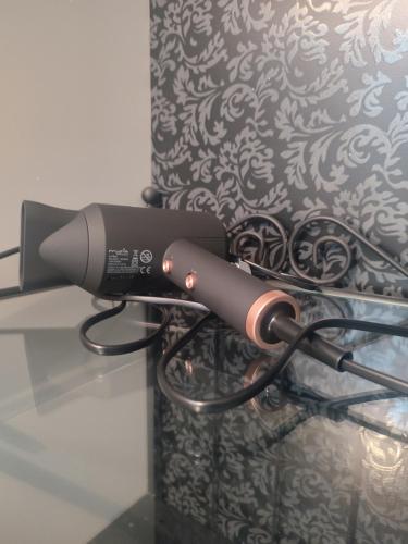 a hair dryer is attached to a wall at The Moon Residence in Bucharest