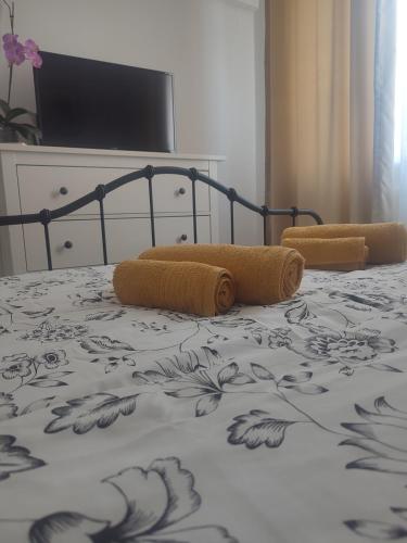 a bed with two pillows on top of it at The Moon Residence in Bucharest