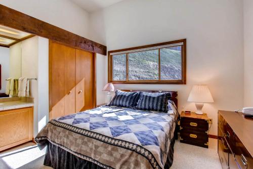 a bedroom with a bed and a window at The Plaza Condominiums by Crested Butte Mountain Resort in Mount Crested Butte