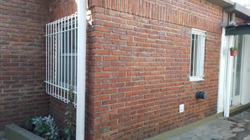a brick wall with a gate on the side of a building at LO DE CHUCHO in Don Torcuato