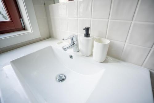 a bathroom sink with a faucet and two toilets on it at Host Wise - Peaceful Amazing Apartment - Ace Location in Porto