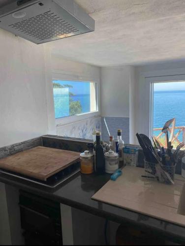 a kitchen with a counter top with a window at Mare e cielo in Porticello