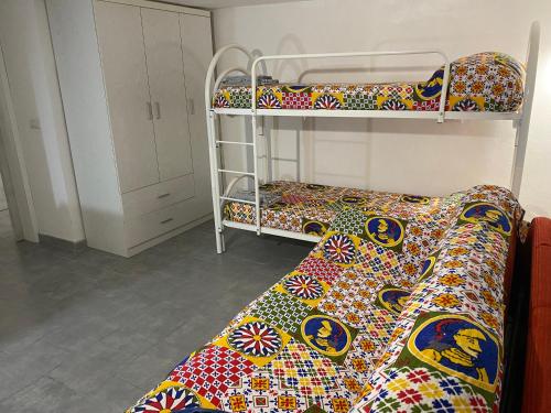 a room with two bunk beds and a couch at Mare e cielo in Porticello