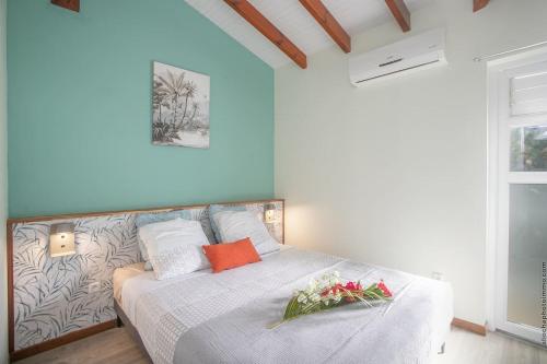 a bedroom with a bed with flowers on it at Villa Patio Azur in Les Trois-Îlets