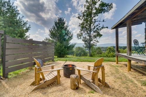 a couple of chairs sitting next to a fire pit at Rustic Baileys Retreat Cabin Near Wineries! in Crozet