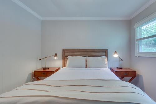 a white bedroom with a large bed with two night stands at Charlottesville Getaway in Baileys Retreat! in Crozet