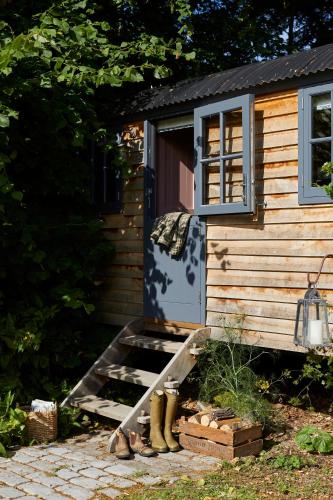 a house with a blue door and boots outside at Rufflets St Andrews in St. Andrews