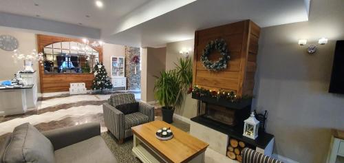 a living room with a couch and a fireplace at Predela 2 Aparthotel in Bansko