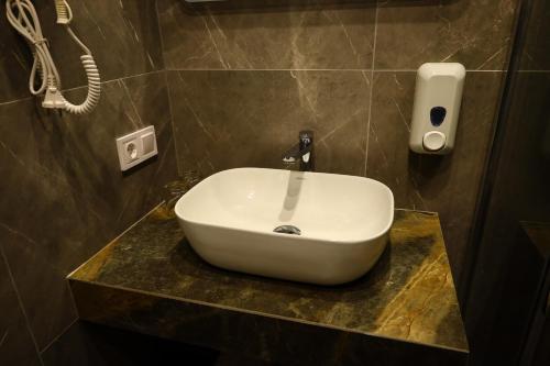 a white sink on a counter in a bathroom at Готель Карпатія in Mukacheve
