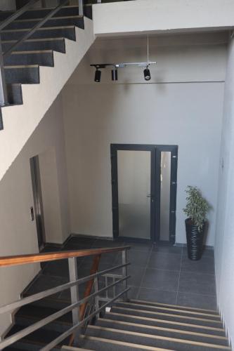 a staircase leading to a door with a potted plant at Готель Карпатія in Mukacheve