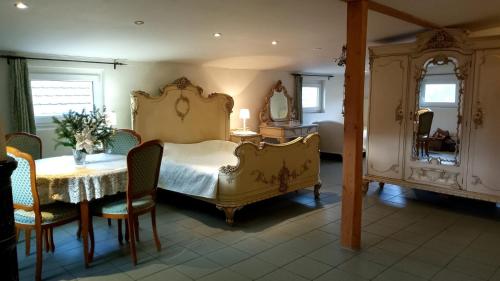 a bedroom with a bed and a table and chairs at Ubytovani Sarka in Čistá