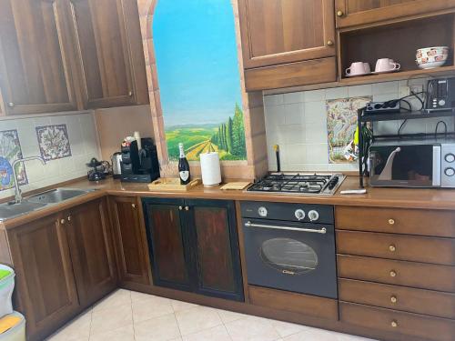 a kitchen with wooden cabinets and a stove top oven at DA ARMÀ in La Spezia