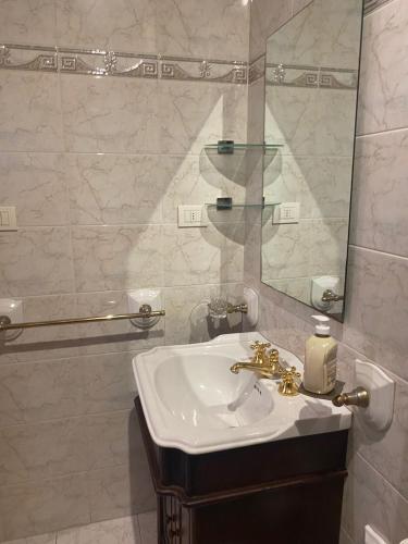 a white bathroom with a sink and a mirror at DA ARMÀ in La Spezia