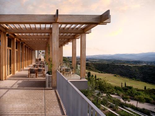 a pergola on the side of a building at Minthis Resort in Paphos City